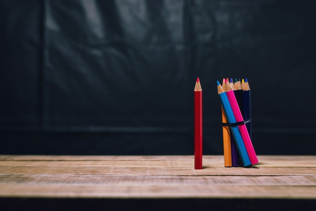 Red pencil from color group on wood table