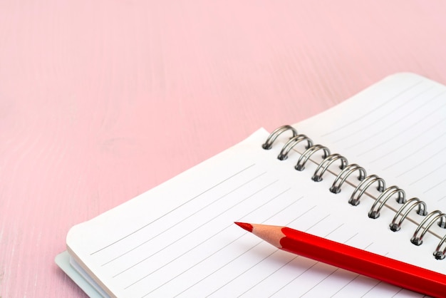 Red pencil and notebook for notes.