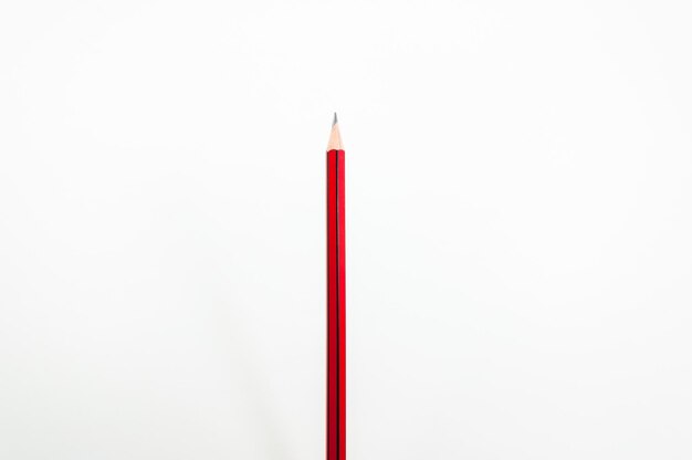 Red pencil on white background