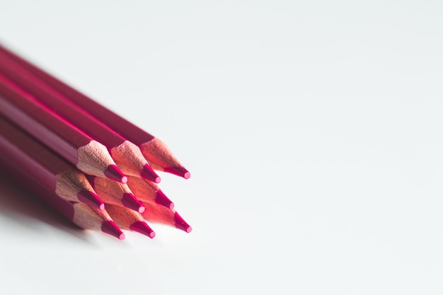 Red pencils on a white background. Office, drawing.