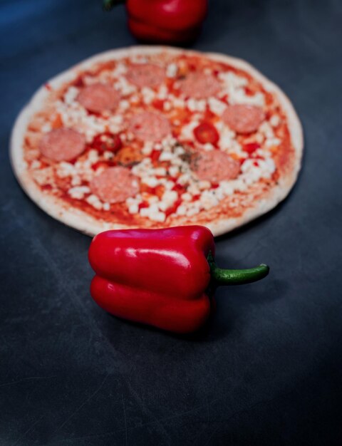 Red pepper on the background of classic Italian pizza