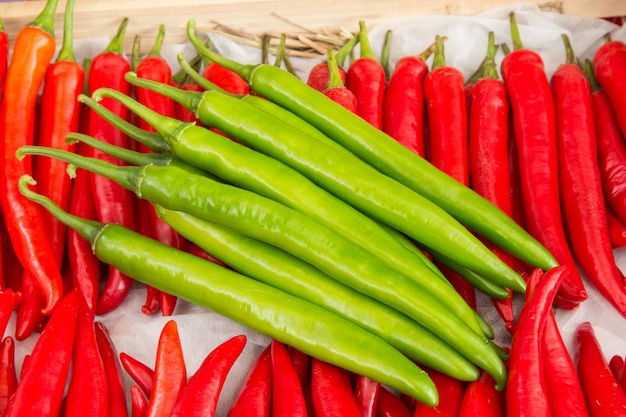 red pepper and green pepper on shelf in market.