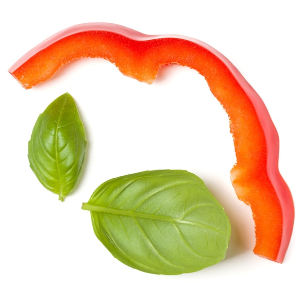 Red pepper slices with basil leaves isolated on white background cutout Top view flat lay