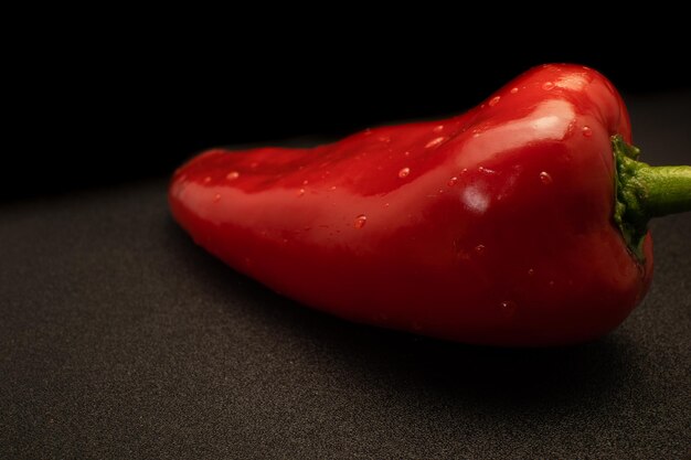 A red pepper with water drops on it