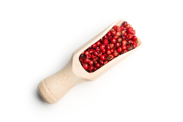 Red peppercorns in a wooden spoon