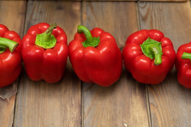 Red peppers on a wooden background