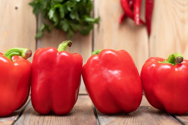 Red peppers on a wooden background