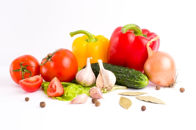 Red peppers and yellow peppers with tomatoes on a white background