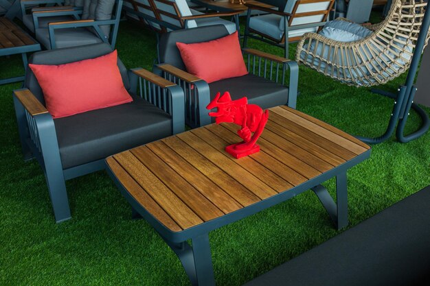 A red pillow on a table with a red dragon on it