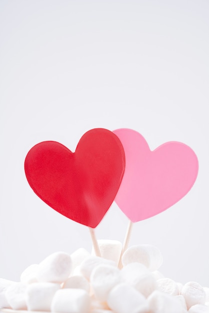 Red and pink hearts in marshmallow on white background. St Valentine concept. Close Up