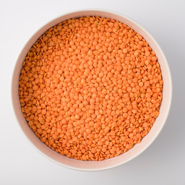 Red or Pink Lentils on round large white plate. isolated on white. Top view.