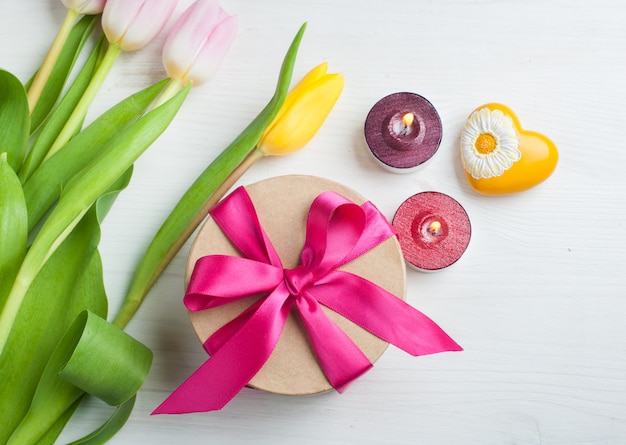 Red pink yellow tulips and gift box with red ribbon