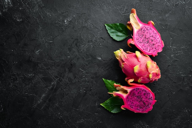 Red Pitahaya on a black background Fruit Dragon Tropical Fruits Top view Free space for text