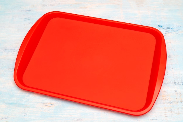 Red plastic dining tray on the table.