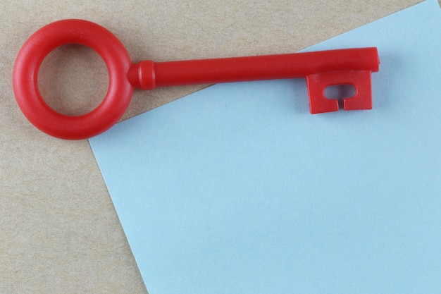 Red Plastic key is placed on Blue Paper Note.