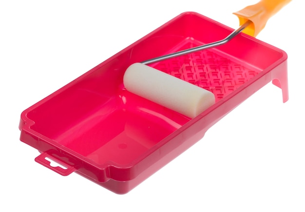 Red plastic paint tray and white roller