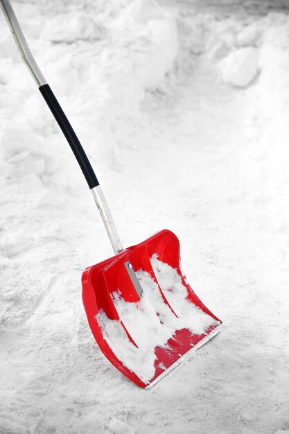 Red plastic shovel for snow