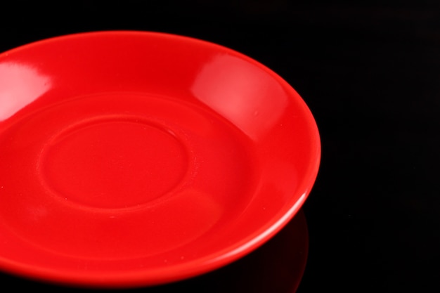 Red plate on a black surface