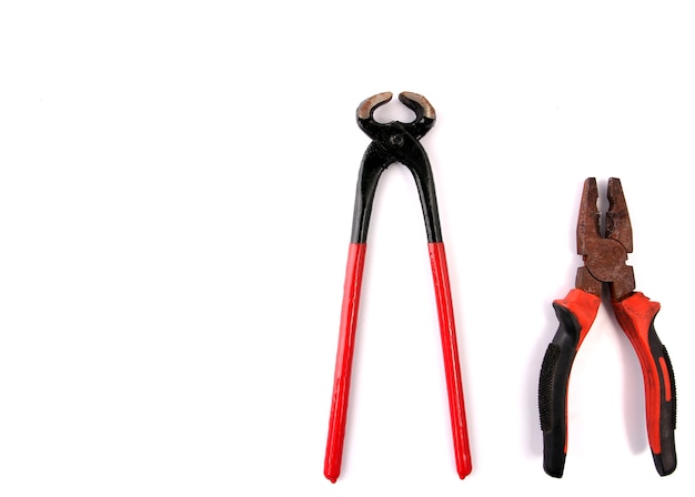 Red pliers with white backdrop.