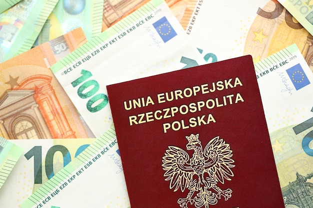 Photo red polish passport and big amount of european euro money bills close up