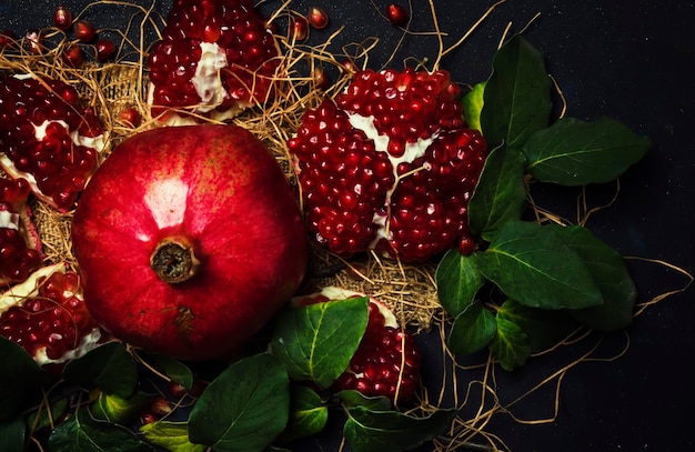 Red Pomegranate In The Starw Rustic Style Black Background Top View