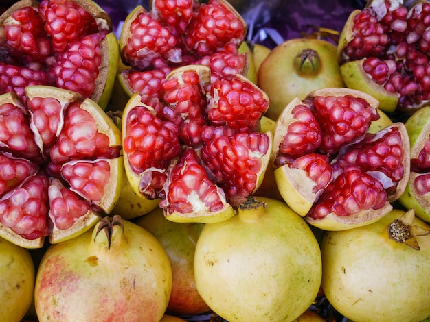 Red pomegranate, whole and broken on the market