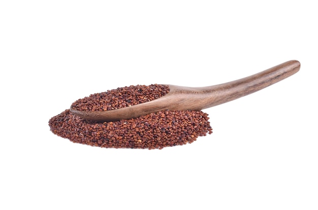 Red quinoa seeds in wooden spoon isolated on white background