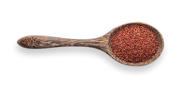 Red quinoa in woodrn spoon isolated