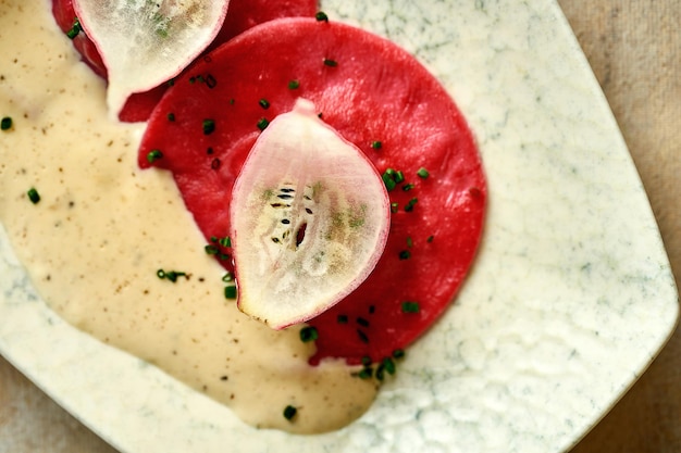 Red ravioli with spinach in sauce Closeup selective focus