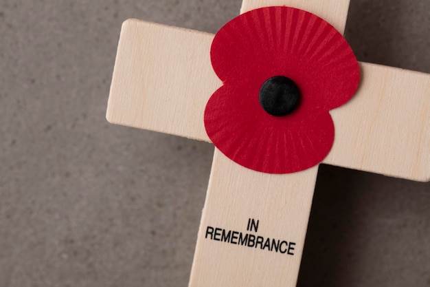 A red remembrance poppy on a wooden cross military remembrance
day concept