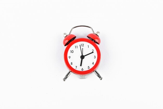 Red retro alarm clock on white. Round red alarm clock on white