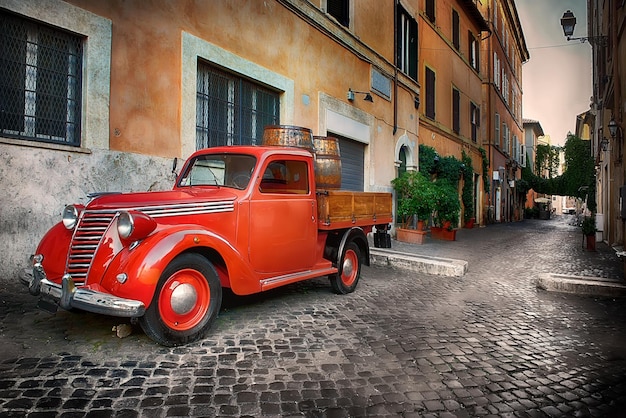 Red retro car on the street of Trastevere in Rome, Italy