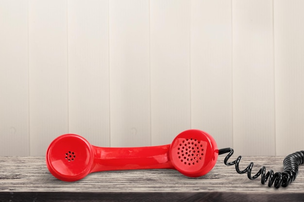 Red retro telephone handset on the desk