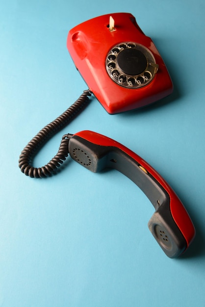 Red retro telephoneon color background