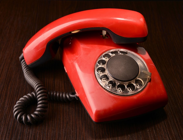 Red retro telephoneon dark background