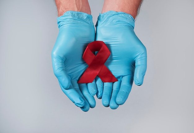Red ribbon as symbol of aids and hiv support and hope