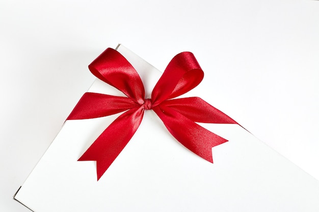 Red ribbon bow on white background. 