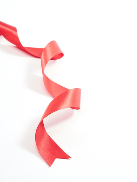 Red ribbon curved isolated on white