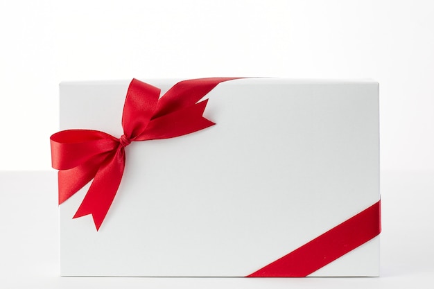 Red ribbon gift box on the white