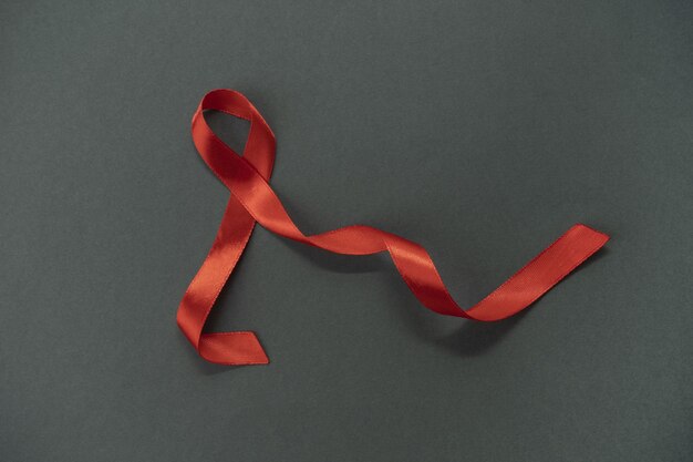 Red ribbon hiv awareness concept world aids day and world sexual health day.