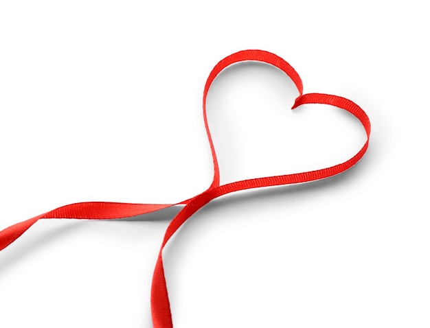 Photo red ribbon in shape of heart isolated on white