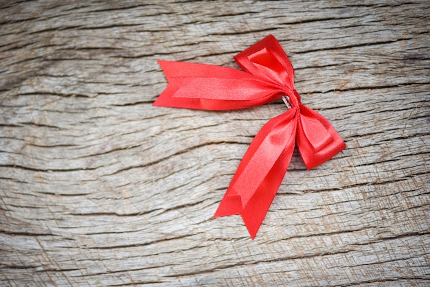 Red ribbon on wooden table