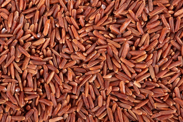 Red rice background Whole grain raw brown rice Top view