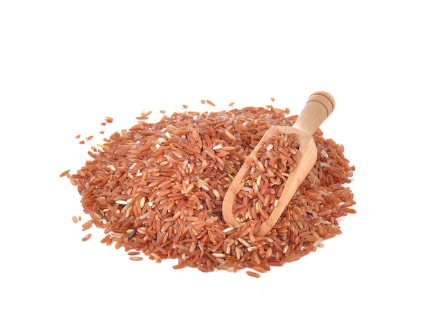 Red rice in a scoop on the table