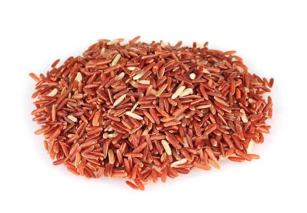 Red rice uncooked in a heap isolated on a white background