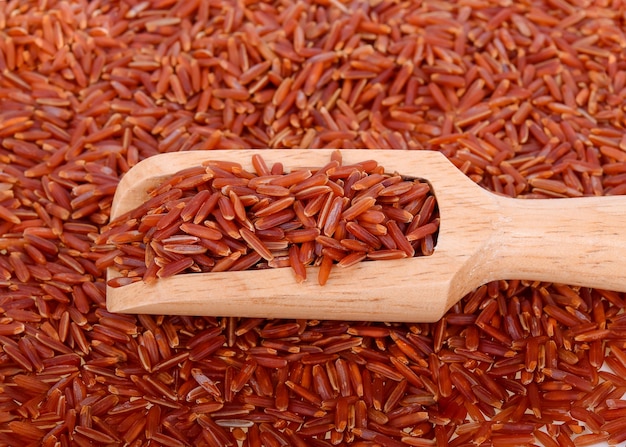 Photo red rice in  wooden spoon