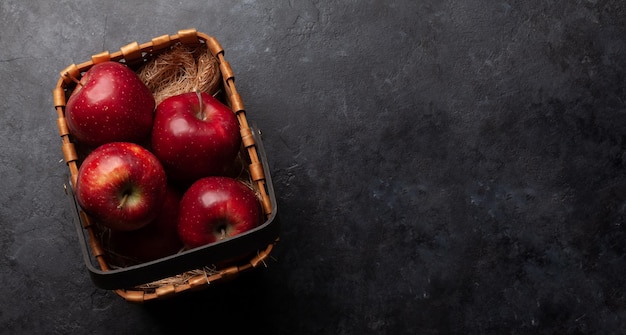 Red ripe apple fruits in basket