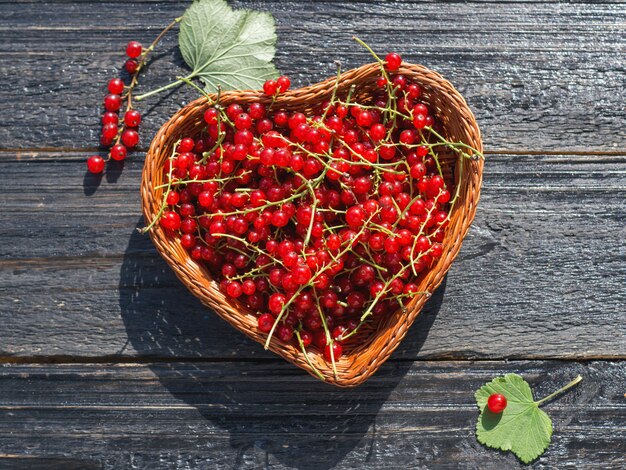 Red ripe currants in a wooden basket