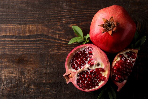 Red ripe pomegranate on a wooden table