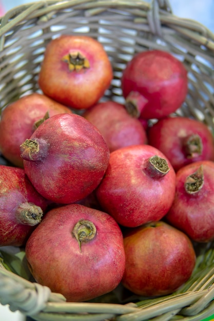 Red, ripe pomegranates in the basket.